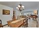 Elegant dining room featuring a wooden table with chandelier lighting, adjacent to the living room and piano at 2811 Barret Ave, Plant City, FL 33566