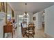Well-lit dining room with chandelier lighting, a wooden table, and patio view, next to the buffet and hallway at 2811 Barret Ave, Plant City, FL 33566