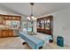 Dining room with french doors overlooking a pool area, light fixtures, and wooden cabinets at 2811 Barret Ave, Plant City, FL 33566
