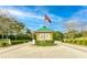 Welcoming community entrance with gatehouse, American flag, and beautiful landscaping at 2811 Barret Ave, Plant City, FL 33566