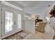 Foyer featuring decorative glass doors, tile flooring, and a glimpse into the living area at 2811 Barret Ave, Plant City, FL 33566