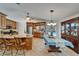 Spacious kitchen with granite countertops, stainless steel appliances, and an adjacent dining area overlooking the pool at 2811 Barret Ave, Plant City, FL 33566