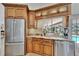 Modern kitchen with stainless steel appliances, granite countertops, and a view of the lanai and pool at 2811 Barret Ave, Plant City, FL 33566