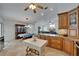 Open-concept kitchen with granite counters, wood cabinetry, and an island, seamlessly connected to dining and living areas at 2811 Barret Ave, Plant City, FL 33566