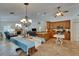 Open-concept living room features a fireplace, tile flooring, and kitchen with wood cabinetry at 2811 Barret Ave, Plant City, FL 33566