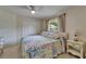 Cozy main bedroom with floral bedding, ceiling fan, and a bright window at 2811 Barret Ave, Plant City, FL 33566
