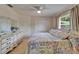 Inviting main bedroom with ceiling fan, ample dresser space, and window for natural light at 2811 Barret Ave, Plant City, FL 33566