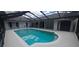 Screened in-ground pool with an adjacent patio and views of the main house and a storage shed at 2811 Barret Ave, Plant City, FL 33566