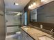Bathroom features a double sink vanity and glass enclosed shower at 3041 Short Leaf St, Wesley Chapel, FL 33543