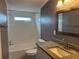 Bathroom with single sink vanity and shower with a tub at 3041 Short Leaf St, Wesley Chapel, FL 33543