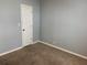 Bedroom with carpet flooring, a closet door, and light grey walls at 3041 Short Leaf St, Wesley Chapel, FL 33543