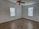 Bedroom featuring wood-look flooring and windows allowing natural light at 3041 Short Leaf St, Wesley Chapel, FL 33543