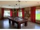 Billiard room featuring a pool table, red curtains, and ample natural light at 3041 Short Leaf St, Wesley Chapel, FL 33543
