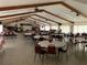 Large community hall with tables, chairs, and a stage area at 3041 Short Leaf St, Wesley Chapel, FL 33543