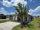 Attractive single-story home featuring covered parking with a spacious driveway, lush lawn, and appealing curb appeal at 3041 Short Leaf St, Wesley Chapel, FL 33543