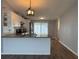 Open-concept kitchen featuring granite countertops, stainless steel appliances, and white cabinets at 3041 Short Leaf St, Wesley Chapel, FL 33543