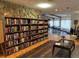 Community library with large bookshelf and gathering area with tables at 3041 Short Leaf St, Wesley Chapel, FL 33543