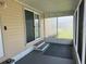 View of screened porch with slider door and neutral rug for comfortable outdoor living at 3041 Short Leaf St, Wesley Chapel, FL 33543