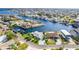 Stunning aerial view of waterfront homes on canals, showcasing the coastal community and beautiful blue water at 3181 Gulf Winds Cir, Hernando Beach, FL 34607