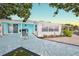Back patio area with tile flooring, seating area and access to the rear of the home at 3181 Gulf Winds Cir, Hernando Beach, FL 34607