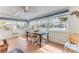 Bright dining area with waterfront views, tile floors, ceiling fan, and a dining table with seating at 3181 Gulf Winds Cir, Hernando Beach, FL 34607