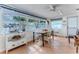 Sunlit dining area features a view of the canal, charming decor, and tile flooring for easy maintenance at 3181 Gulf Winds Cir, Hernando Beach, FL 34607