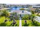 Beautiful waterfront home with lush green lawn and mature palm trees at 3181 Gulf Winds Cir, Hernando Beach, FL 34607