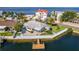 Waterfront home featuring a private dock, seawall, and lush lawn for serene outdoor living and picturesque views at 3181 Gulf Winds Cir, Hernando Beach, FL 34607