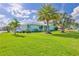 Well-maintained lawn and beautiful landscaping enhance this charming home's curb appeal at 3181 Gulf Winds Cir, Hernando Beach, FL 34607