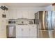 Modern kitchen with stainless steel appliances and sleek white cabinetry at 3181 Gulf Winds Cir, Hernando Beach, FL 34607