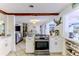 Open-concept kitchen with stainless steel oven, view of the dining area and living space at 3181 Gulf Winds Cir, Hernando Beach, FL 34607
