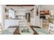 Open kitchen with white cabinetry, stainless appliances and adjacent dining area at 3181 Gulf Winds Cir, Hernando Beach, FL 34607