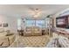 Comfortable living room featuring tile flooring, neutral colors, and ample lighting at 3181 Gulf Winds Cir, Hernando Beach, FL 34607