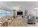 Cozy living room with comfortable seating, a ceiling fan, and ample natural light at 3181 Gulf Winds Cir, Hernando Beach, FL 34607