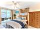 Cozy main bedroom featuring a ceiling fan, neutral decor, and access to the patio at 3181 Gulf Winds Cir, Hernando Beach, FL 34607