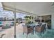Elegant outdoor patio with a dining table, perfect for enjoying meals with a waterfront view at 3181 Gulf Winds Cir, Hernando Beach, FL 34607
