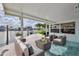 Inviting covered patio overlooking the water, furnished with a comfortable seating area at 3181 Gulf Winds Cir, Hernando Beach, FL 34607