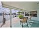 Charming covered patio overlooking the serene waterfront with ample space for outdoor seating at 3181 Gulf Winds Cir, Hernando Beach, FL 34607