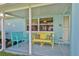 Inviting porch with colorful seating and charming nautical decor accents at 3181 Gulf Winds Cir, Hernando Beach, FL 34607