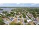Aerial view of a residential neighborhood near a lake, featuring tree-lined streets and varied home styles with pools at 3317 Nakora Dr, Tampa, FL 33618