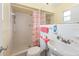 Bathroom showcasing a shower with a curtain, toilet, and sink with a mirror at 3317 Nakora Dr, Tampa, FL 33618