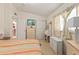 Bedroom featuring a striped bedspread, dresser, and a window letting in natural light at 3317 Nakora Dr, Tampa, FL 33618