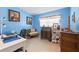 Bright bedroom with blue walls, vintage furniture, and a window with blinds at 3317 Nakora Dr, Tampa, FL 33618