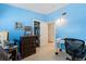 Bedroom with blue walls, desk, and view into an open closet space at 3317 Nakora Dr, Tampa, FL 33618