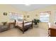 Bright bedroom with yellow walls, natural light, and simple furnishings at 3317 Nakora Dr, Tampa, FL 33618