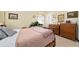 Cozy bedroom with vintage furniture, wood-framed bed, and natural light at 3317 Nakora Dr, Tampa, FL 33618