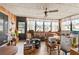 Light-filled sunroom with wood paneled walls and ceiling fan, offering potential for a relaxing retreat at 3317 Nakora Dr, Tampa, FL 33618