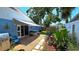 Backyard featuring a hot tub, patio, and flourishing landscape with trees and flower pots at 3907 Orchard Hill Cir, Palm Harbor, FL 34684