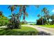 Picturesque view of the community lake featuring a gazebo and lush landscaping, ideal for outdoor enjoyment at 3907 Orchard Hill Cir, Palm Harbor, FL 34684