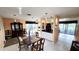 Bright dining area with stylish furnishings and lighting, seamlessly connecting to the kitchen at 3907 Orchard Hill Cir, Palm Harbor, FL 34684